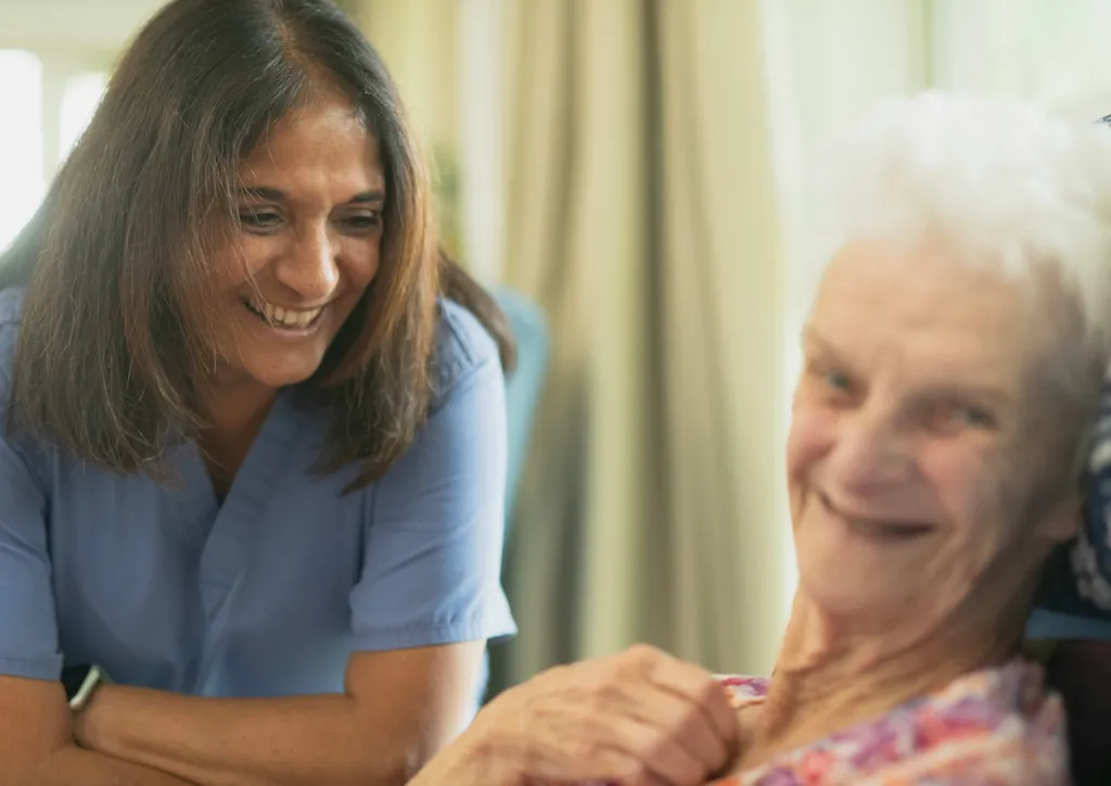 A caregiver sharing a warm smile with a patient