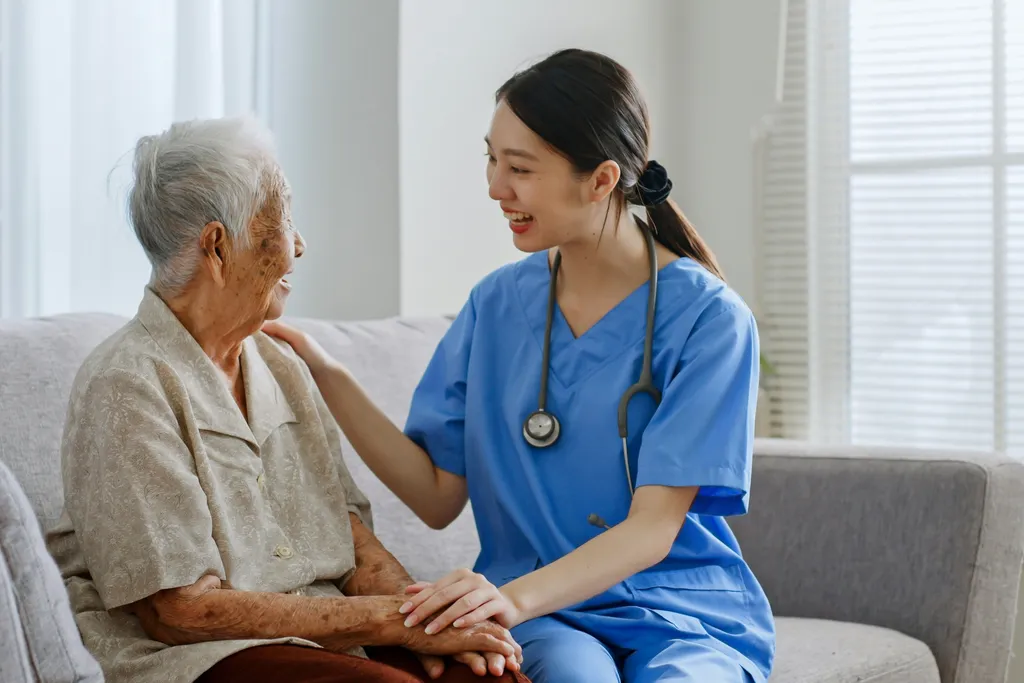 A nurse providing compassionate care to a patient at home