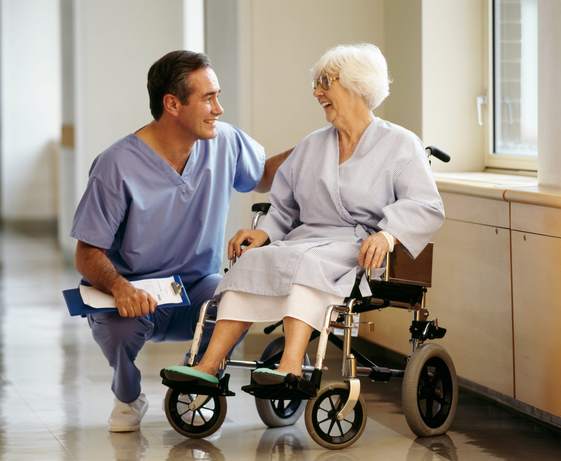 A nurse assisting a patient in a wheelchair with compassionate care