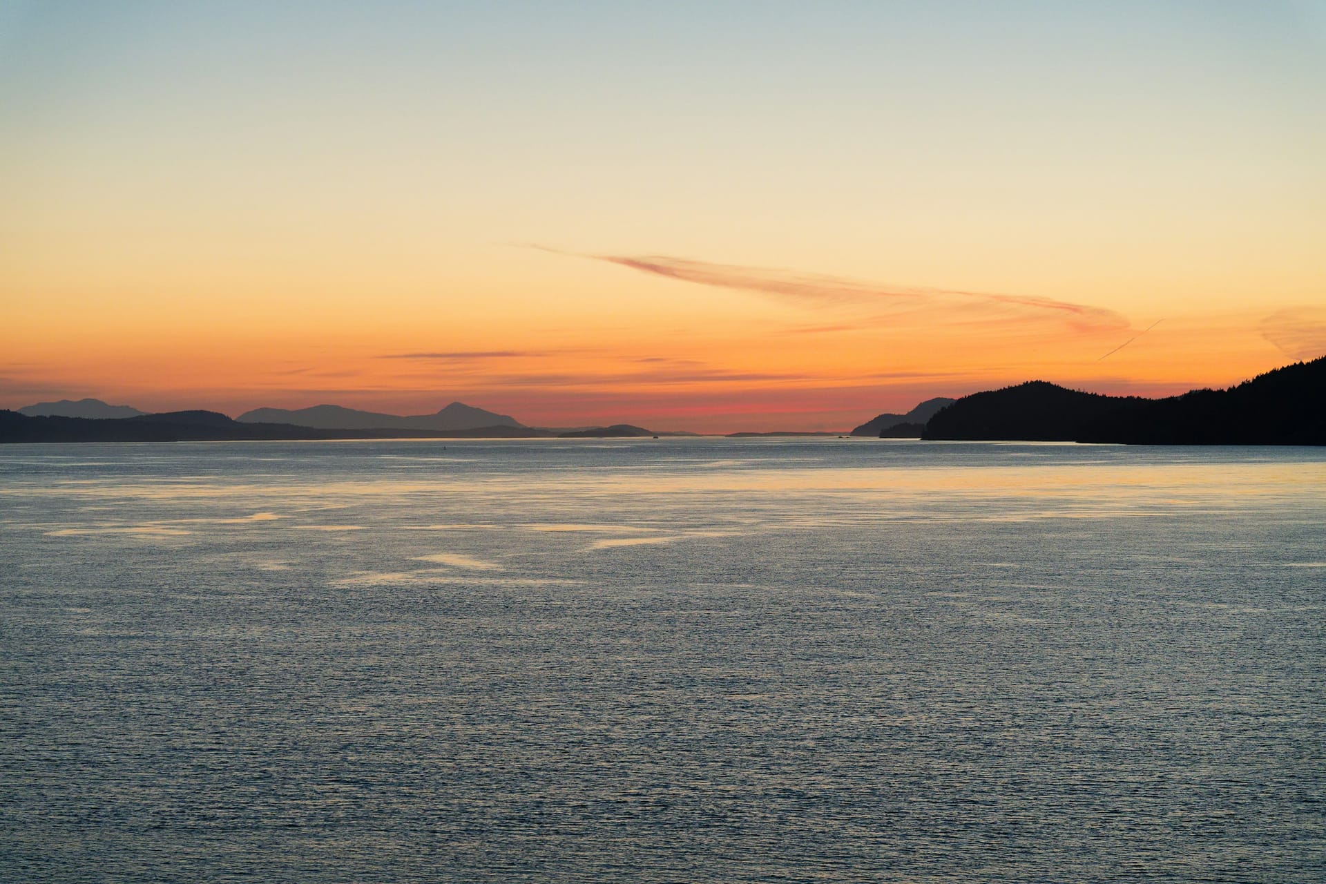 Sunset over the Pacific with distant silhouettes of land
